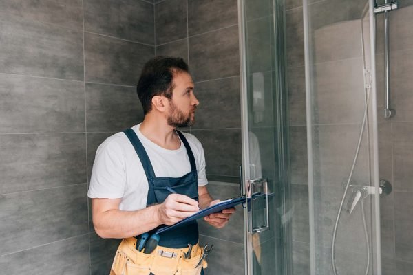 adult-male-plumber-making-notes-in-clipboard-while-resize.jpg adult-male-plumber-making-notes-in-clipboard-while-resize.jpg